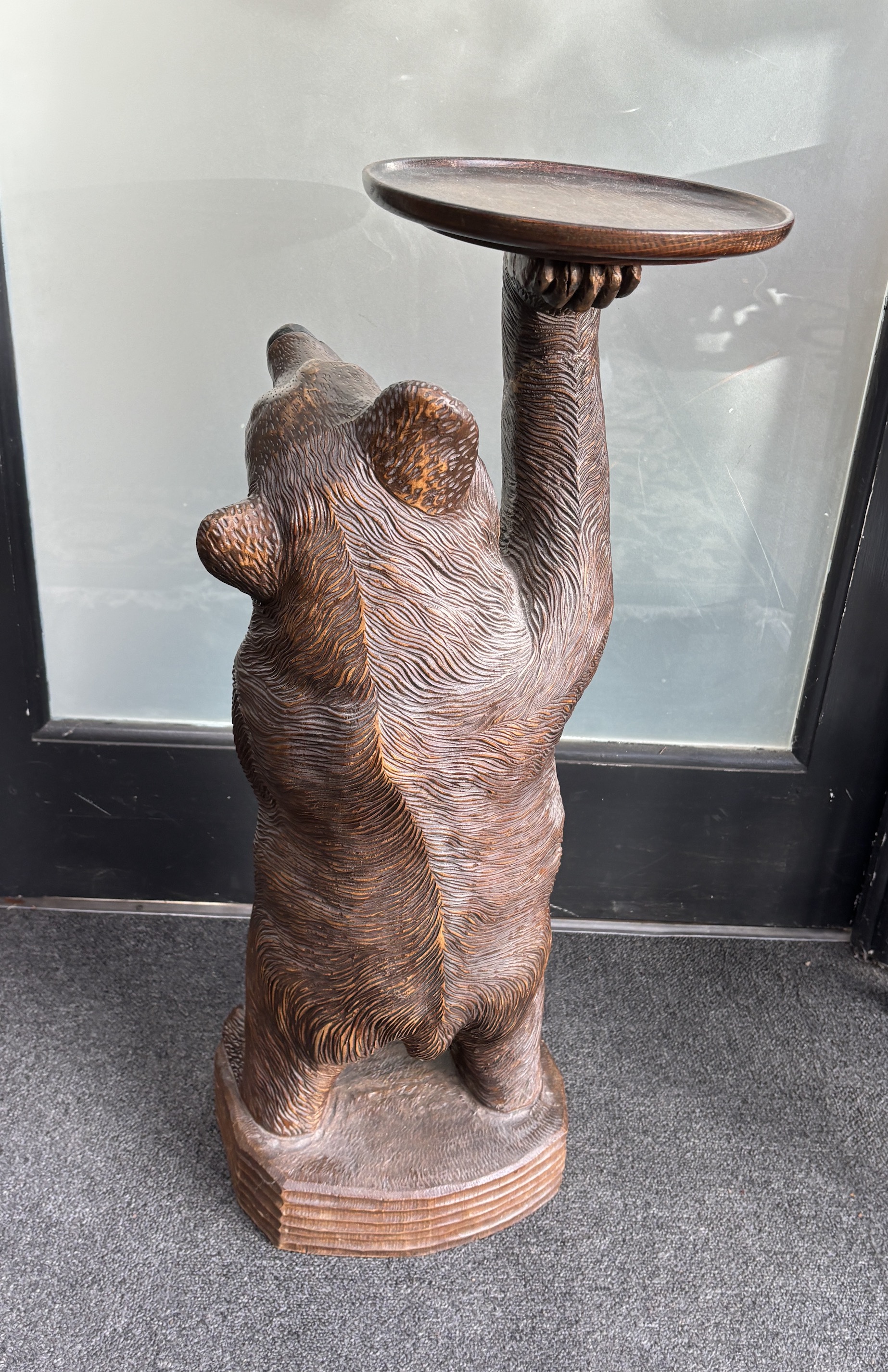 A large Black Forest figure of a bear, with later oak dish top, 71cm high